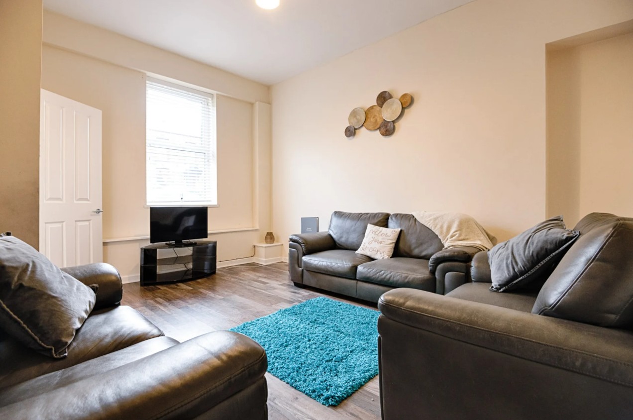 Woodlands House ground floor lounge with sofas and rug